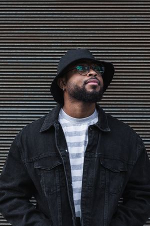 Black hipster man in hat looking away