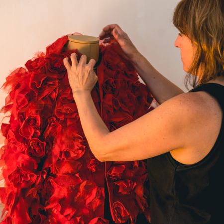 Close-up of a fashion designer dressing a mannequin