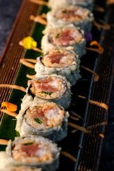 Delicious fried sushi with cream on tray