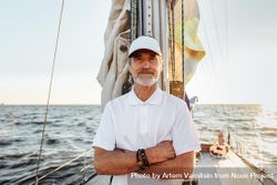 Portrait of older man with arms cross on his sailboat 0KLRy5