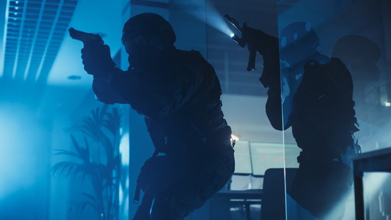 Soldiers with Rifles and Flashlights Surveil and Cover Surroundings.
