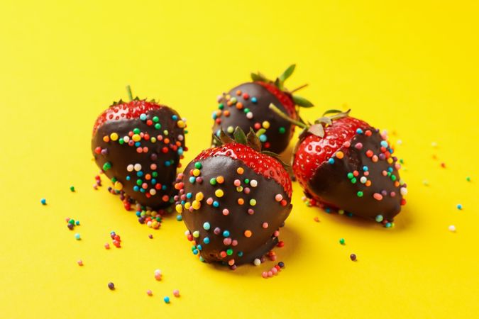 Chocolate fondue. Strawberry in chocolate on yellow background