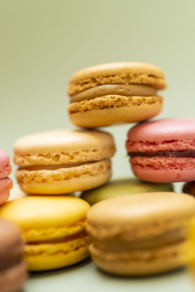 Pile of fine French macaroon on a green table