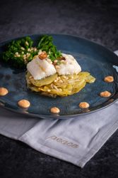 Delicious gratin with fish and sauce with broccoli