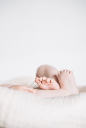Charming cute baby feet and fingers of new born