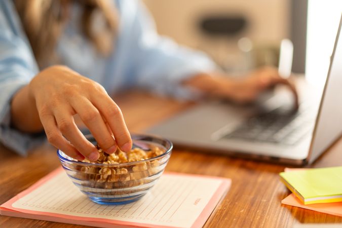 Healthy Snack at Work - Hand Reaching for Nuts on Desk