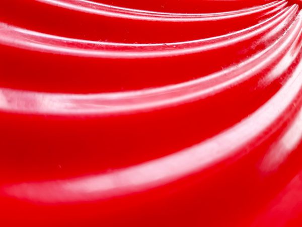 Red glossy abstract background with swirl texture