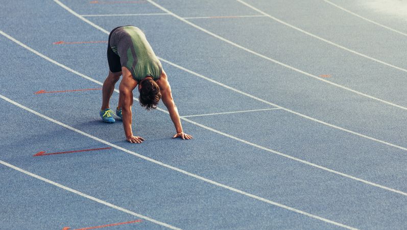 Sprinter stretching on the track