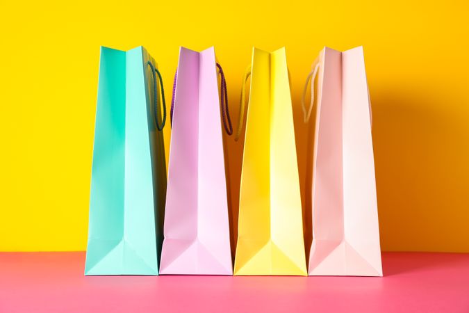 Color paper bags on multicolor background, space for text