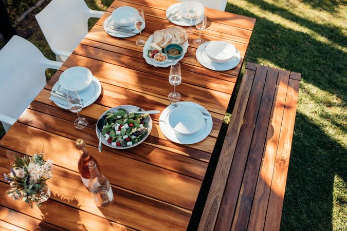 Picnic table outdoors with food and drink
