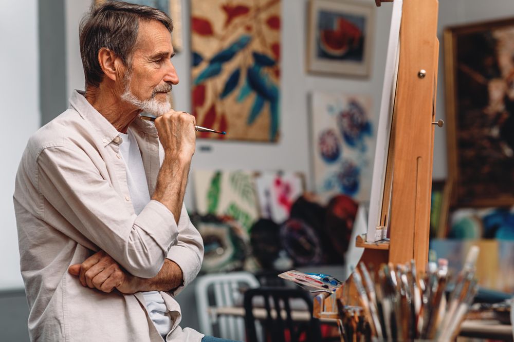 Male painter thinking about his work