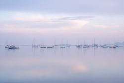 Boats on calm sea water in evening