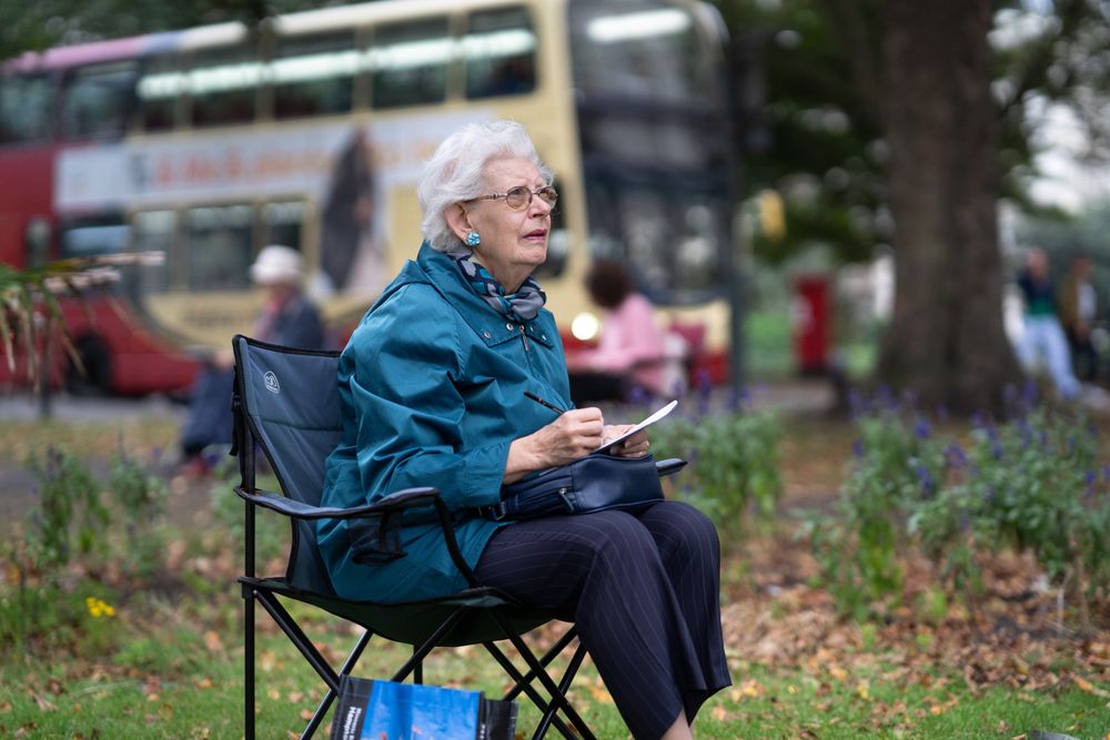 Woman sitting in park drawing
