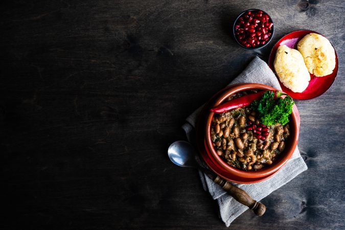 Top view of Georgian bean dish on wooden table with copy space