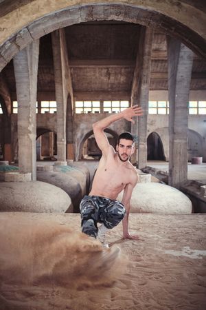 Guy during break dance in dusty cathedral