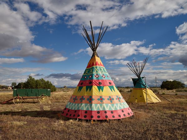 Colorful Native American tipis on grassy prairie