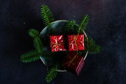 Christmas table setting with decorative gift boxes and fir