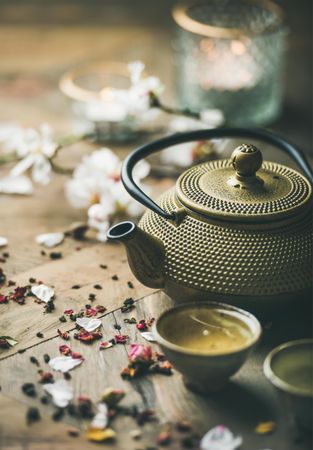 Close up of golden teapot and tiny cups