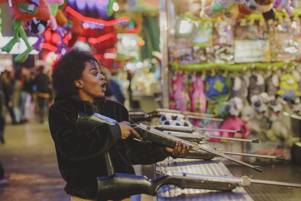Black woman shooting in amusement park
