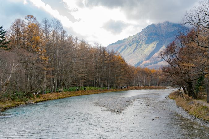 landscape view of japan alps mountain with natural forest, blue river on autumn season at kamikochi Nagano.