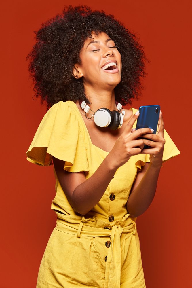 Trendy Black woman using smartphone