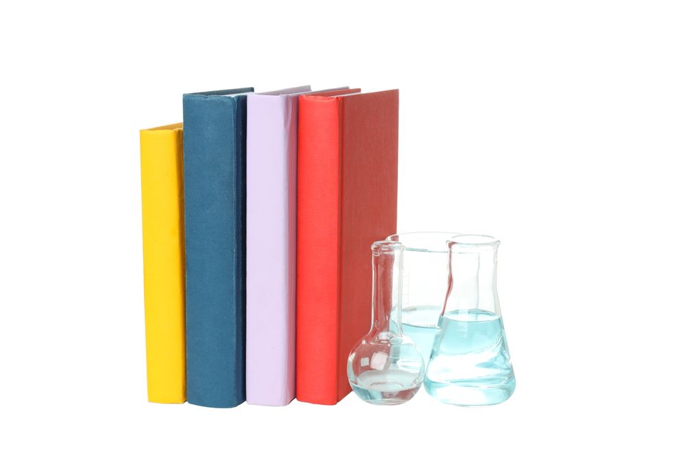 Books and flasks, isolated on light background