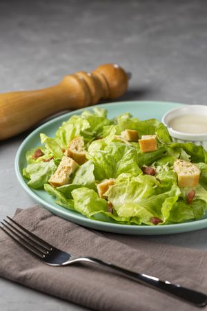 Caesar salad with croutons and bacon.