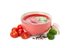 Bowl of tomato in plain studio shoot with raw tomatoes and garlic