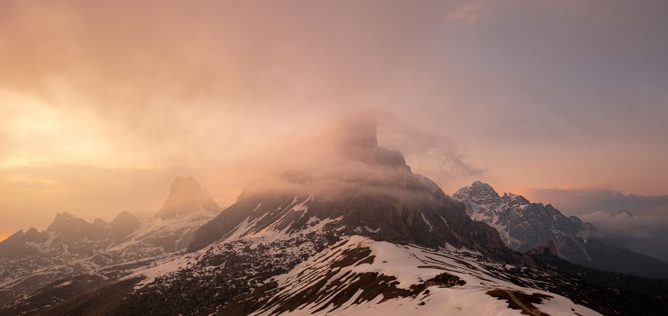 Mountain peak in foggy haze at sunset