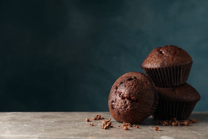 Delicious tasty muffins against blue background. Sweet food