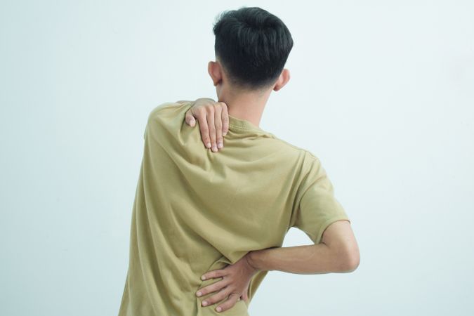 Asian young man feeling pain on his neck