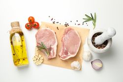 Composition with raw meat and ingredients on light background, top view