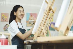 Crafting Inspiration: Female Artist Sketching and Painting in Workshop
