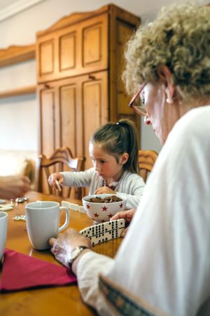 Grandmother and granddaughter playing domino