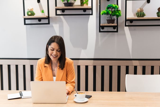 Content woman working on project in cafe