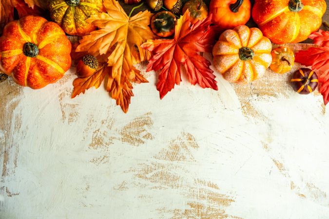 Autumn flatlay with pumpkin ornaments and leaves with space for text