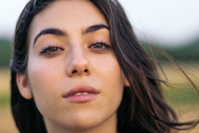 Portrait of a young woman with long hair outdoors