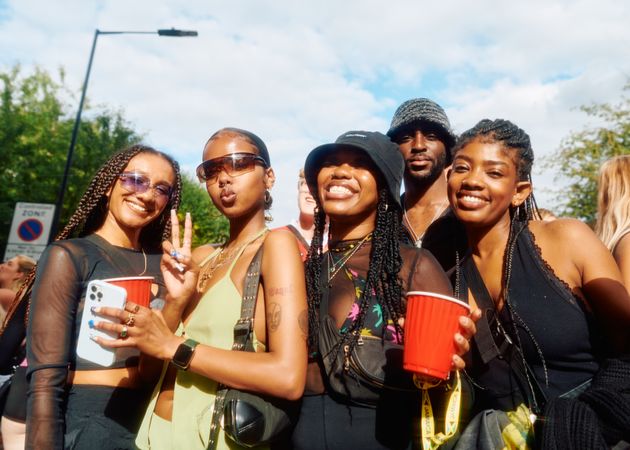 London, England, United Kingdom - August 28, 2022: Group of happy Black friends with drinks outside