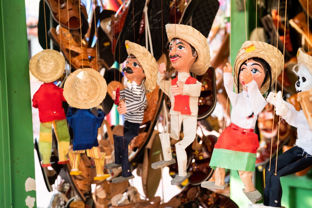 Puppets hanging at market stand for sale