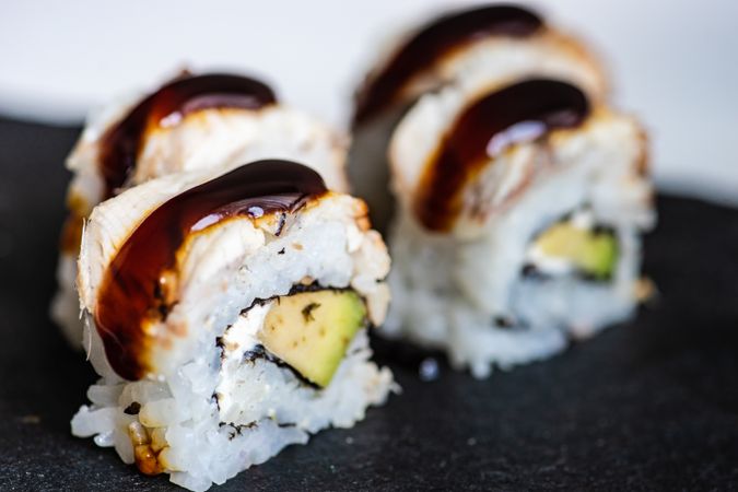 Delicious sushi rolls with crab, avocado, eel sauce and cream cheese