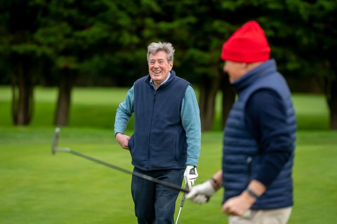 Male friends smiling on golf course