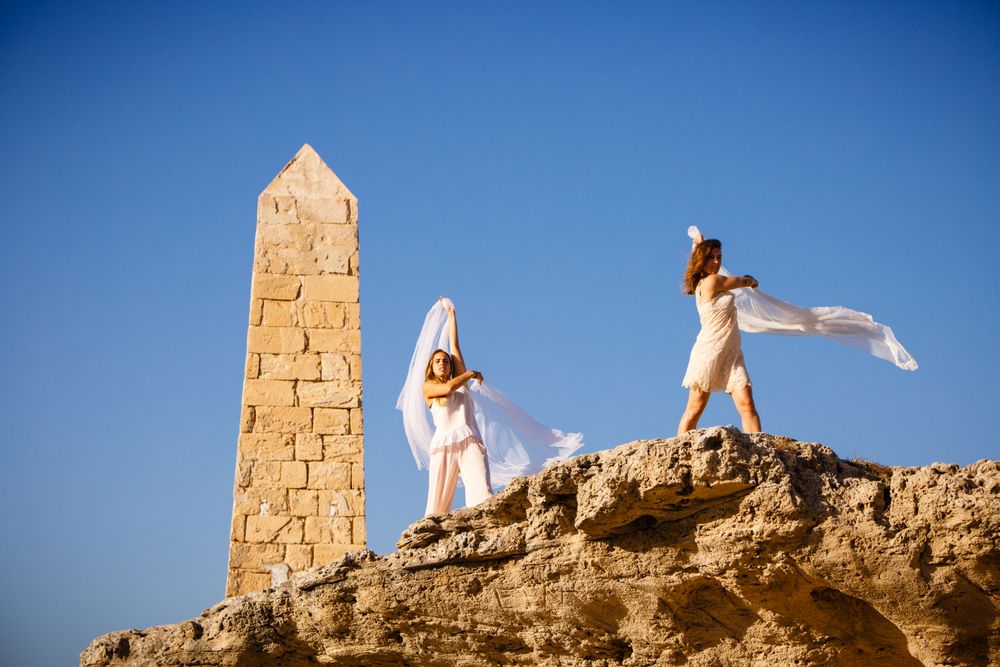 Young women with textile on stone