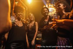 Friends having cocktails in nightclub 0KE8y4