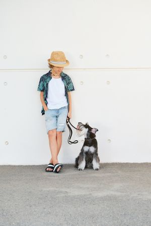 Stylish boy with dog on street