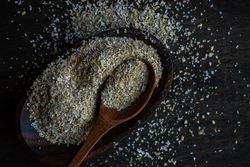 Ground oats with wooden spoon on counter
