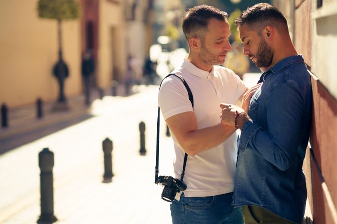 Male couple having romantic moment on bright street