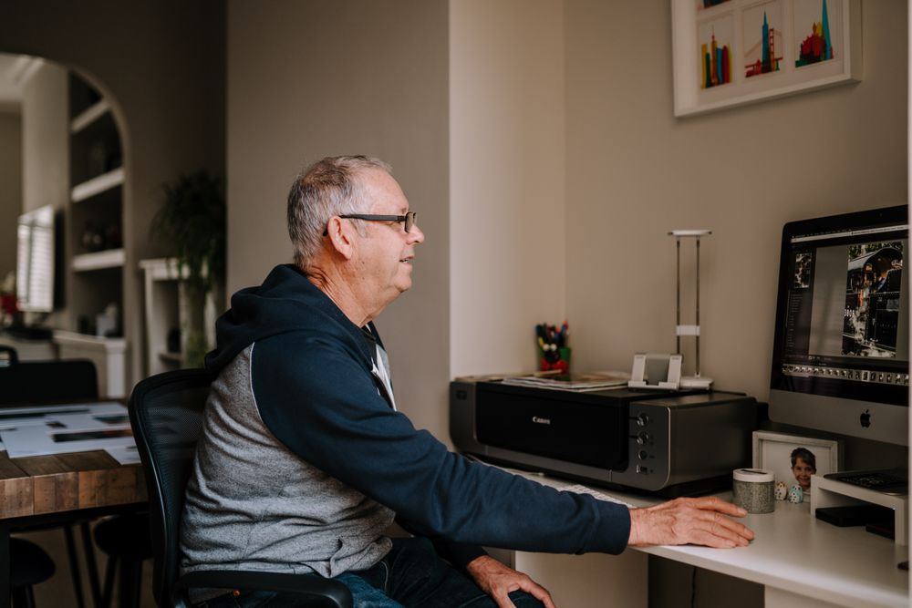 Man editing photos in his home office