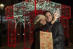 Happy couple standing and taking selfie on smartphone in night