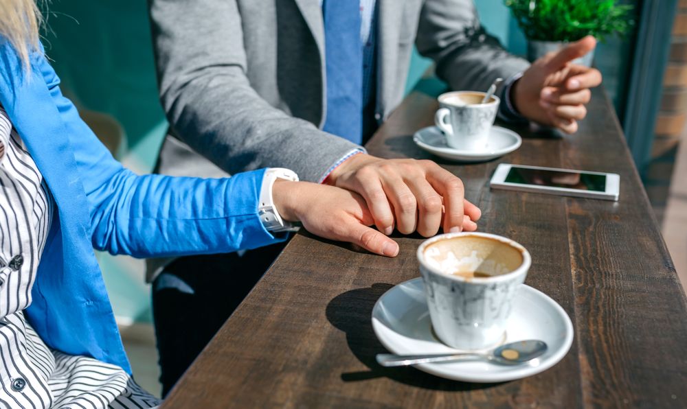 Couple of coworkers holding hands