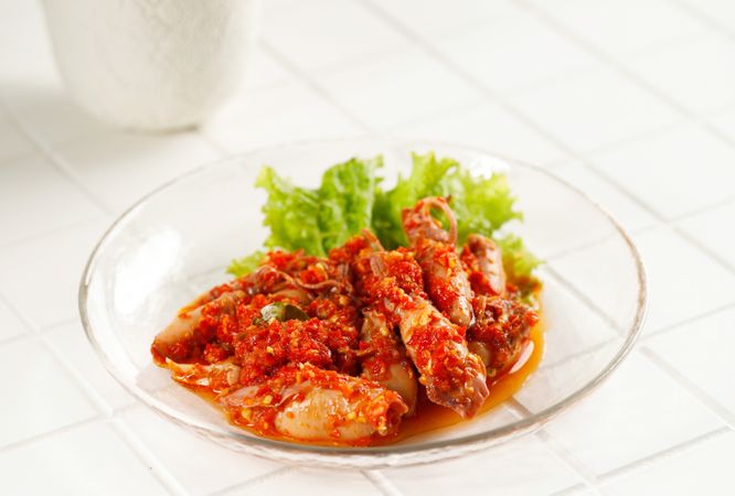 Spicy salted squid dish with lettuce garnish